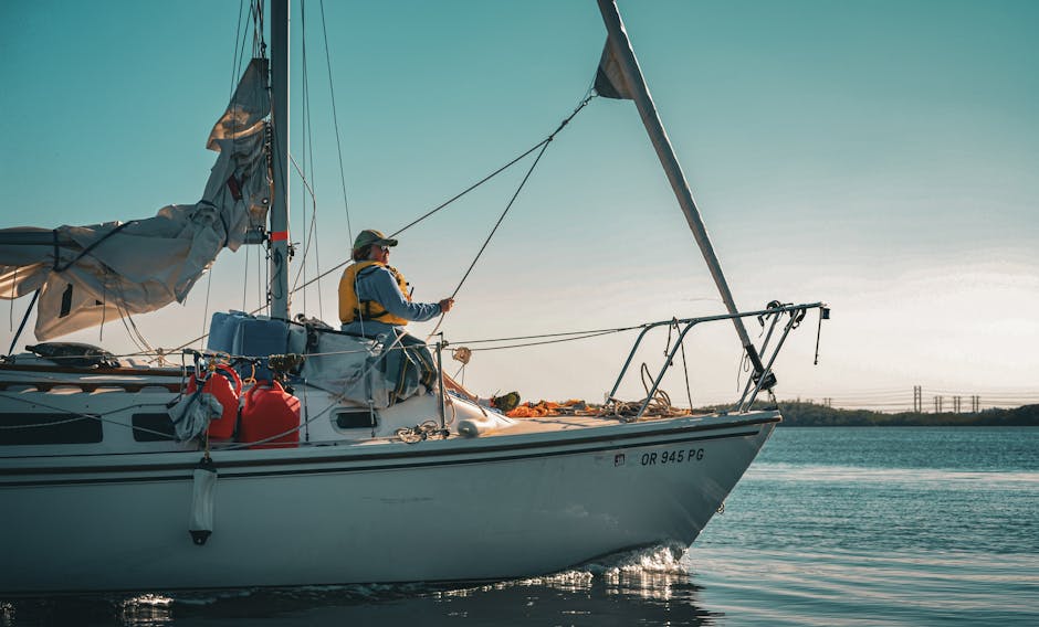 A lone sailor steers his yacht in Miami, capturing the essence of leisure on the sea.
